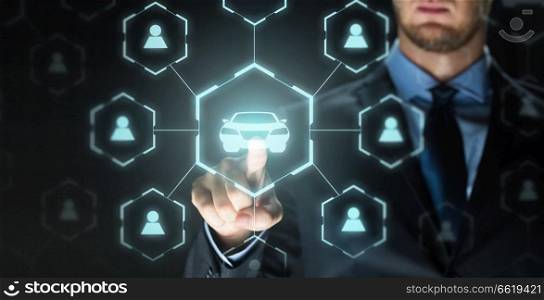 business, rental service and future technology concept - close up of businessman with virtual hologram of car sharing over black background. businessman with virtual hologram of car sharing
