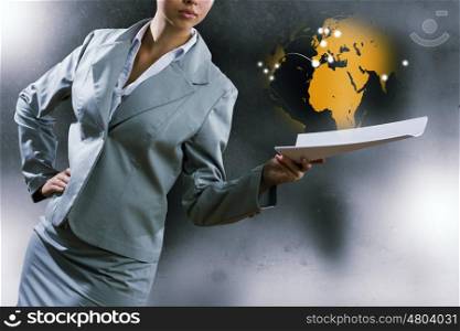 Business report. Close up of businesswoman with papers in hands
