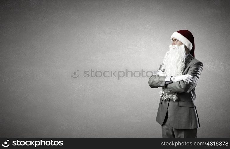 Business Santa. Businessman in Santa hat with arms crossed on chest