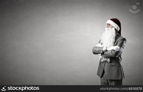 Business Santa. Businessman in Santa hat with arms crossed on chest