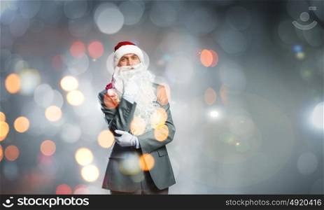 Business Santa. Thoughtful businessman in Santa hat with hand on chin