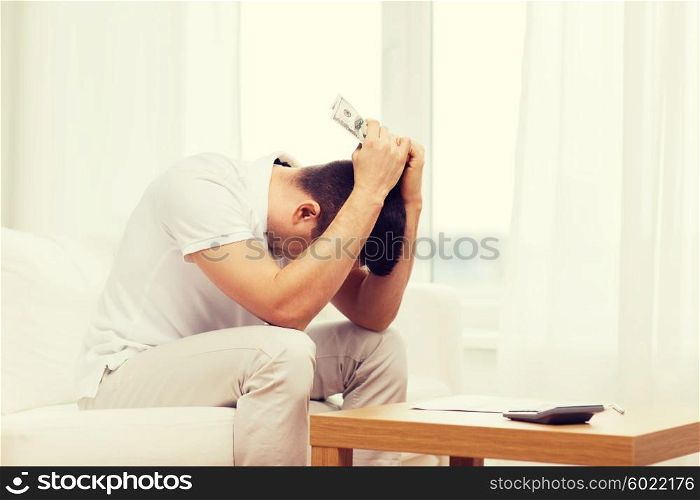 business, savings, financial crisis and people concept - man with money and calculator at home