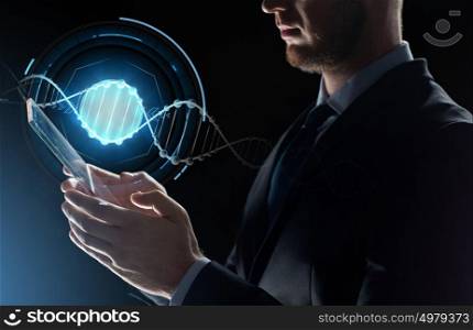 business, science and future technology concept - close up of businessman with transparent tablet pc computer and dna molecule projection over black background. close up of businessman with transparent tablet pc