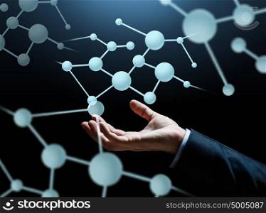 business, science, biology and people concept - close up of businessman hand with molecule projection over dark background. close up of businessman hand with molecule
