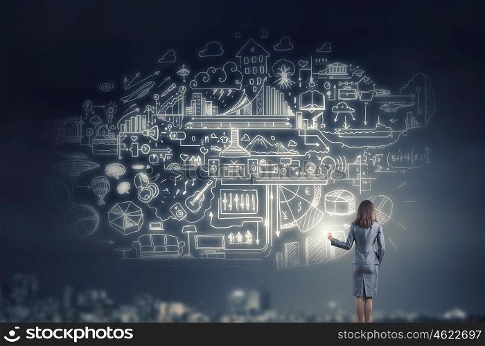Business seminar. Back view of businesswoman drawing business strategy sketch on wall