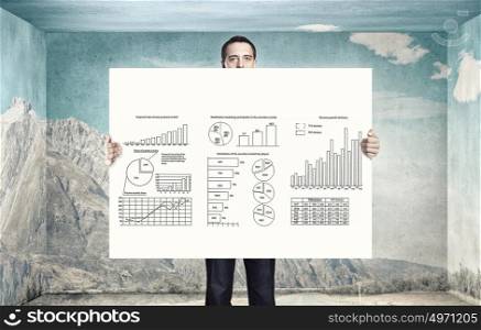 Business seminar. Businessman holding banner with graphs and diagrams concept