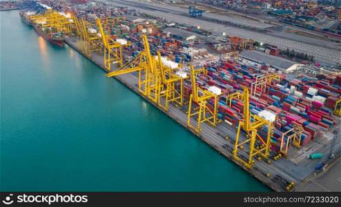 business service and industry shipping cargo containers transportation logistics by the sea and shipping port loading and unloading by crane and trailer aerial top view from drone camera