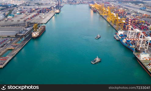 business service and industry shipping cargo containers transportation logistics by the sea and shipping port loading and unloading by crane and trailer aerial top view from drone camera