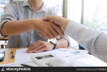business shaking hands in a modern office