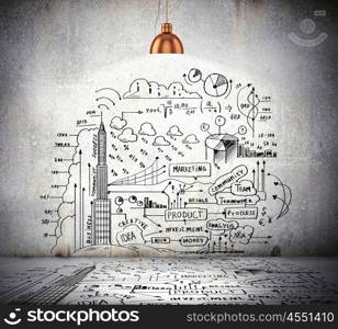 Business sketch on wall. Drawn business plan on wall illuminated by lamp above