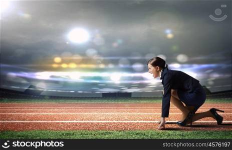 Business start. Side view of businesswoman at stadium standing in start position