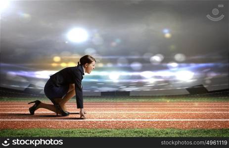 Business start. Side view of businesswoman at stadium standing in start position