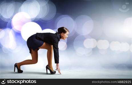Business start. Side view of businesswoman standing in start position