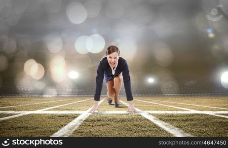 Business start. Young attractive businesswoman at stadium standing in start position