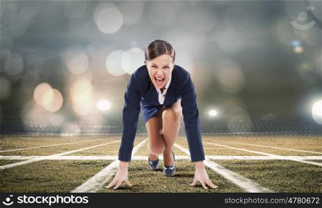 Business start. Young attractive businesswoman at stadium standing in start position