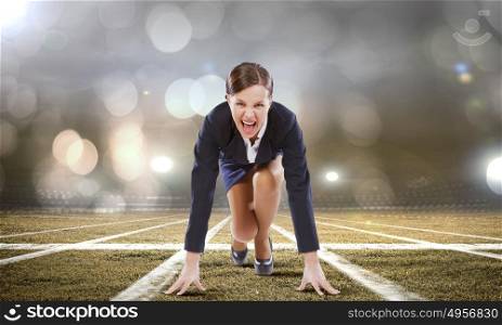 Business start. Young attractive businesswoman at stadium standing in start position