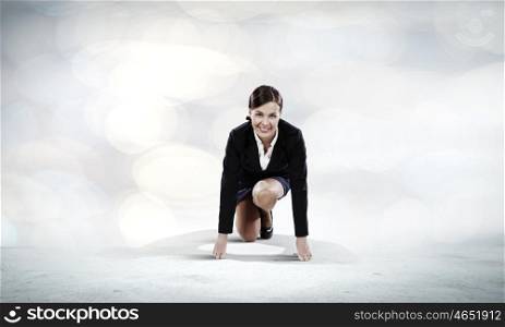 Business start. Young attractive businesswoman standing in start position