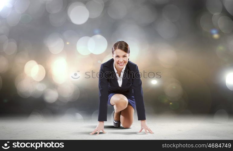 Business start. Young attractive businesswoman standing in start position