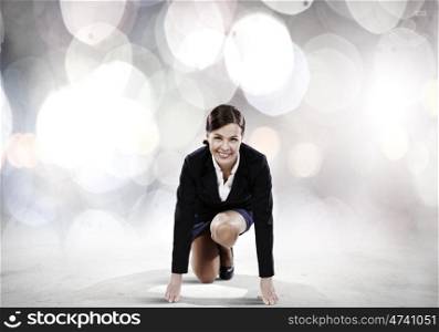 Business start. Young attractive businesswoman standing in start position