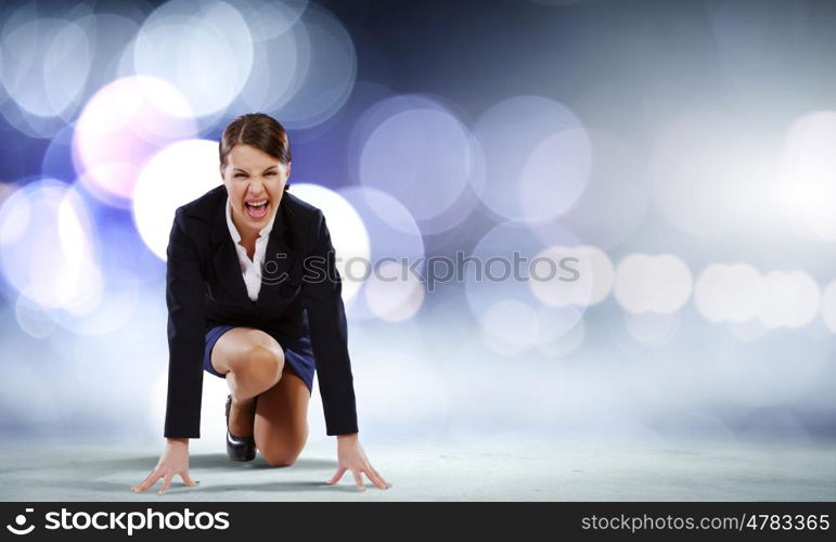 Business start. Young attractive businesswoman standing in start position