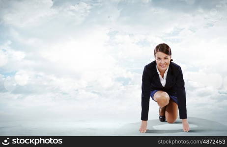 Business start. Young attractive businesswoman standing in start position