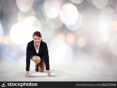 Business start. Young attractive businesswoman standing in start position