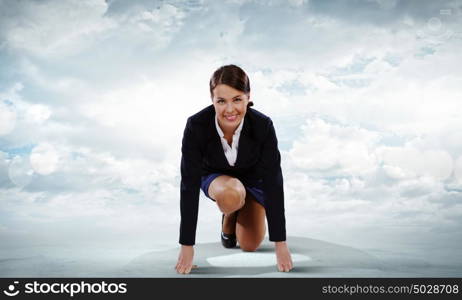 Business start. Young attractive businesswoman standing in start position