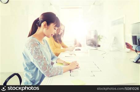 business, startup and people concept - asian architect or creative female office worker with ruler and pencil drawing on blueprint. architect woman drawing on blueprint at office