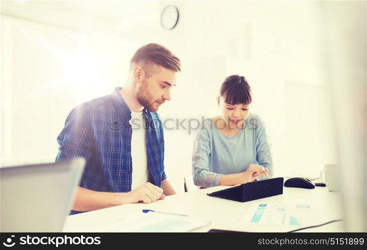 business, startup and people concept - creative team with tablet pc and papers at office. creative team with tablet pc and papers at office