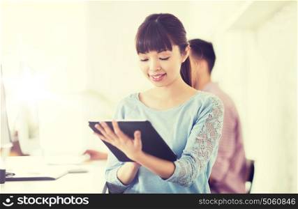 business, startup and people concept - happy asian businesswoman or creative female office worker with tablet pc computer. happy creative female office worker with tablet pc