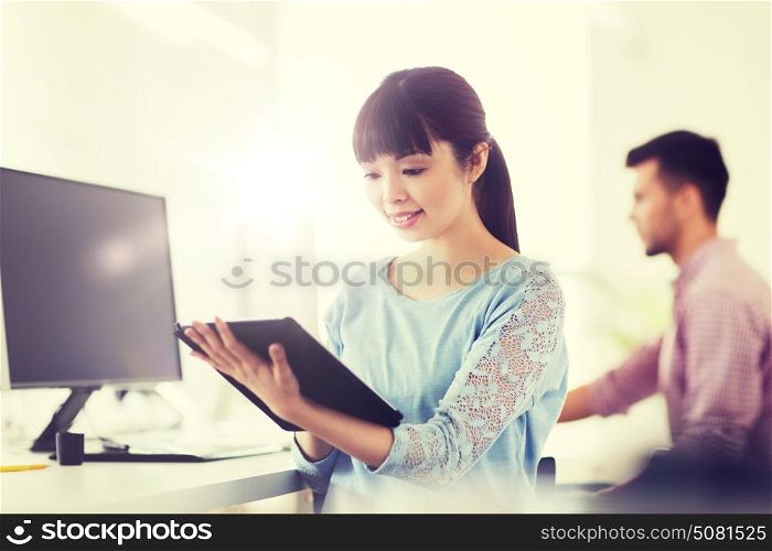 business, startup and people concept - happy asian businesswoman or creative female office worker with tablet pc computer. happy creative female office worker with tablet pc