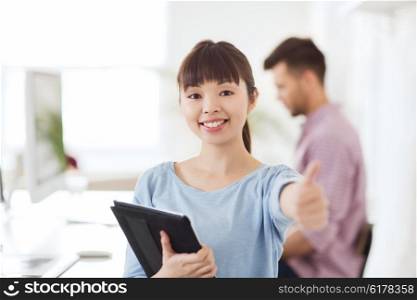 business, startup and people concept - happy asian businesswoman or creative female office worker with tablet pc computer showing thumbs up