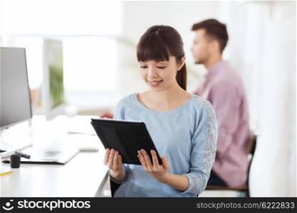 business, startup and people concept - happy asian businesswoman or creative female office worker with tablet pc computer