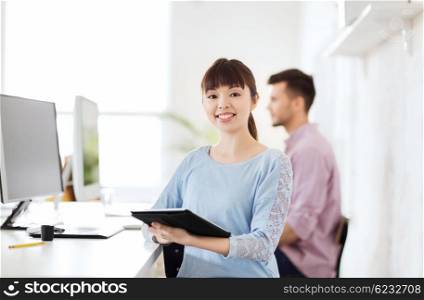 business, startup and people concept - happy asian businesswoman or creative female office worker with tablet pc computer