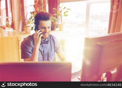 business, startup and people concept - happy businessman or creative male office worker with computer calling on smarphone