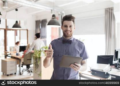 business, startup and people concept - happy businessman or creative male office worker with tablet pc computer