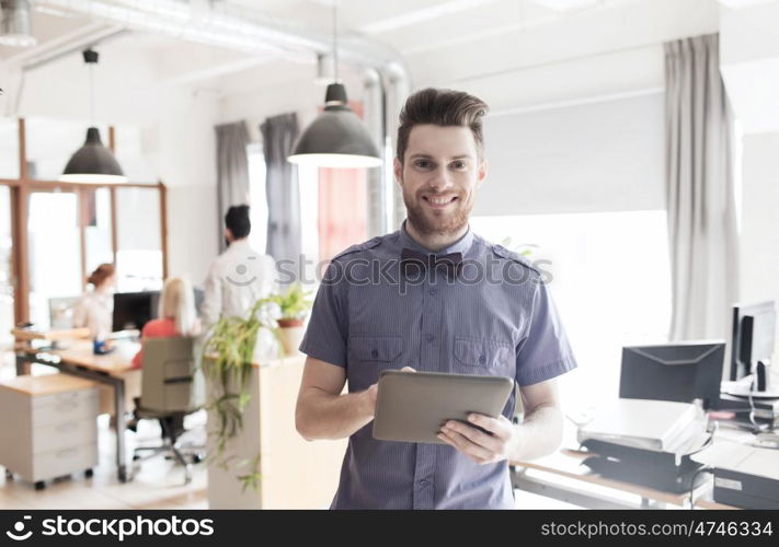 business, startup and people concept - happy businessman or creative male office worker with tablet pc computer