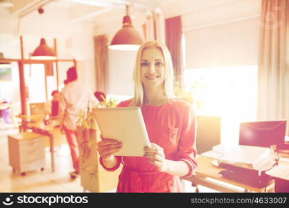 business, startup and people concept - happy businesswoman or creative female office worker with tablet pc computer