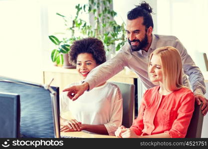 business, startup and people concept - happy creative team networking with computer in office