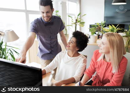 business, startup and people concept - happy creative team networking with computer in office