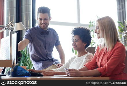 business, startup and people concept - happy creative team networking with computer in office