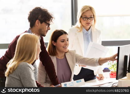 business, startup and people concept - happy creative team networking with computer in office