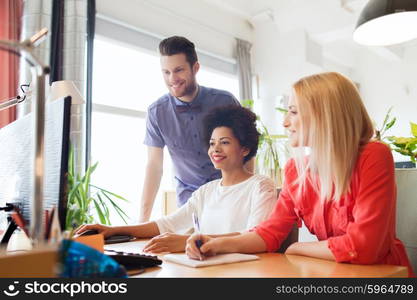 business, startup and people concept - happy creative team networking with computer in office