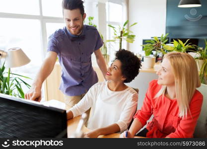 business, startup and people concept - happy creative team networking with computer in office