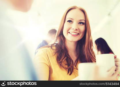 business, startup and people concept - happy creative team or students drinking coffee at office. happy creative team drinking coffee at office