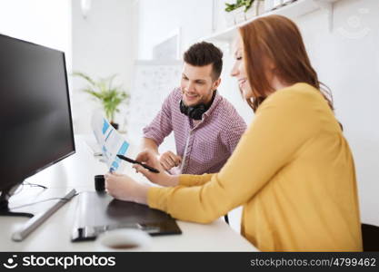 business, startup and people concept - happy creative team with papers and computer at office