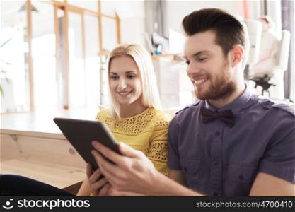 business, startup and people concept - happy creative team with tablet pc computer in office