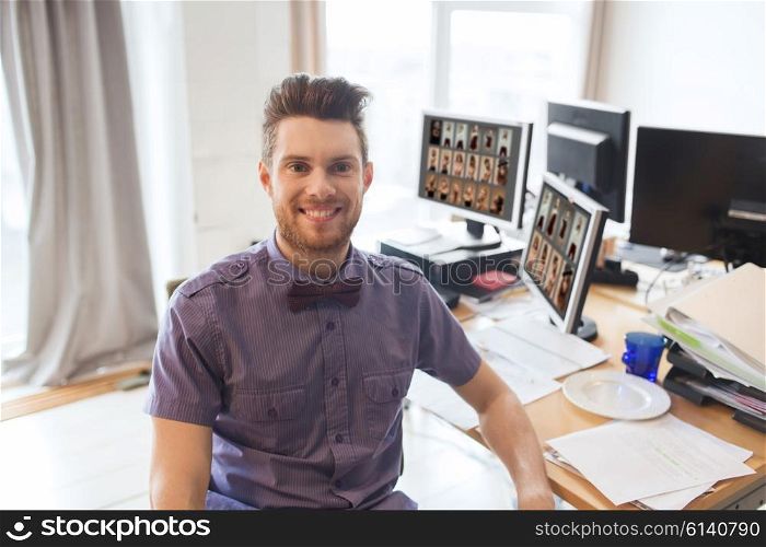 business, startup and people concept - happy youg man with computers at modeling agency office