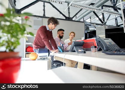 business, startup and people concept - international creative team with tablet pc computers in office. business team working in office