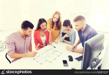 business, startup, architecture and people concept - creative architect team or students with blueprint working at office. creative team with blueprint working at office